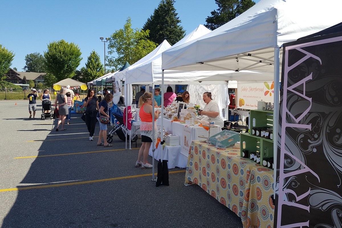 Vendors sell their goods at the Clayton Community Farmer's Market.