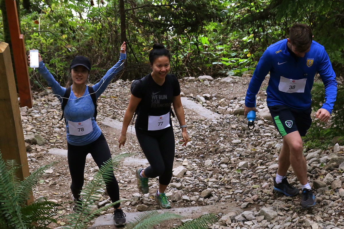 Two women and a man have their picture taken up the Grouse Grind.