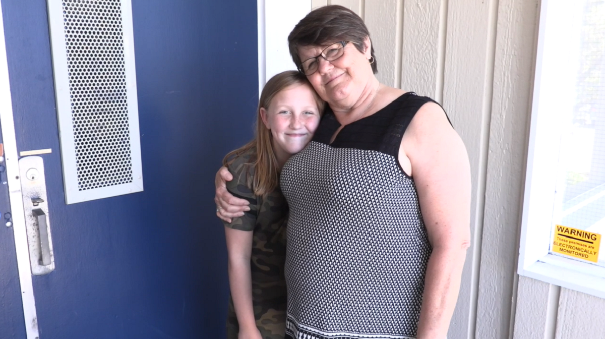 A child hugs her grandmother.