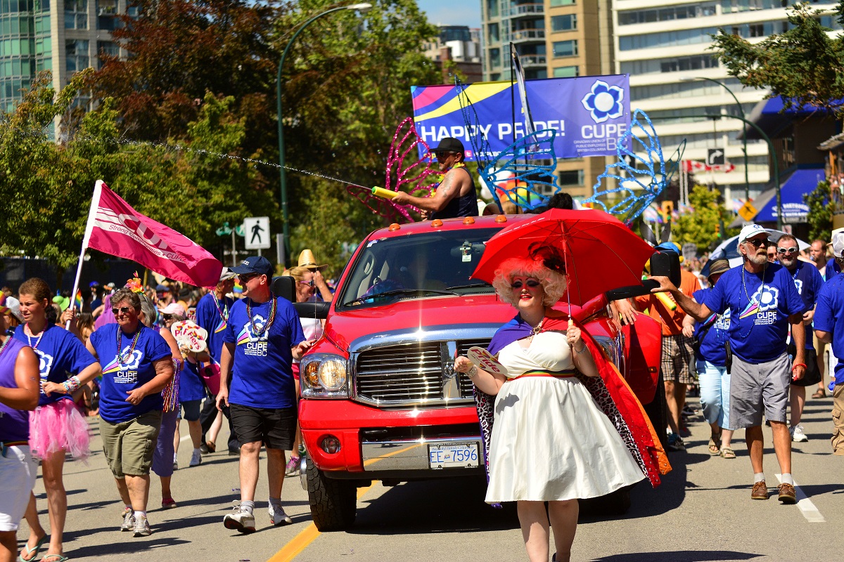 A group in matching purple t-shirts was in a pride parade.